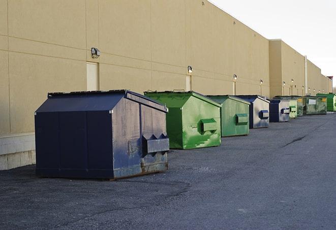 portable, green construction dumpsters serving as a container for scrap materials in Bridge City